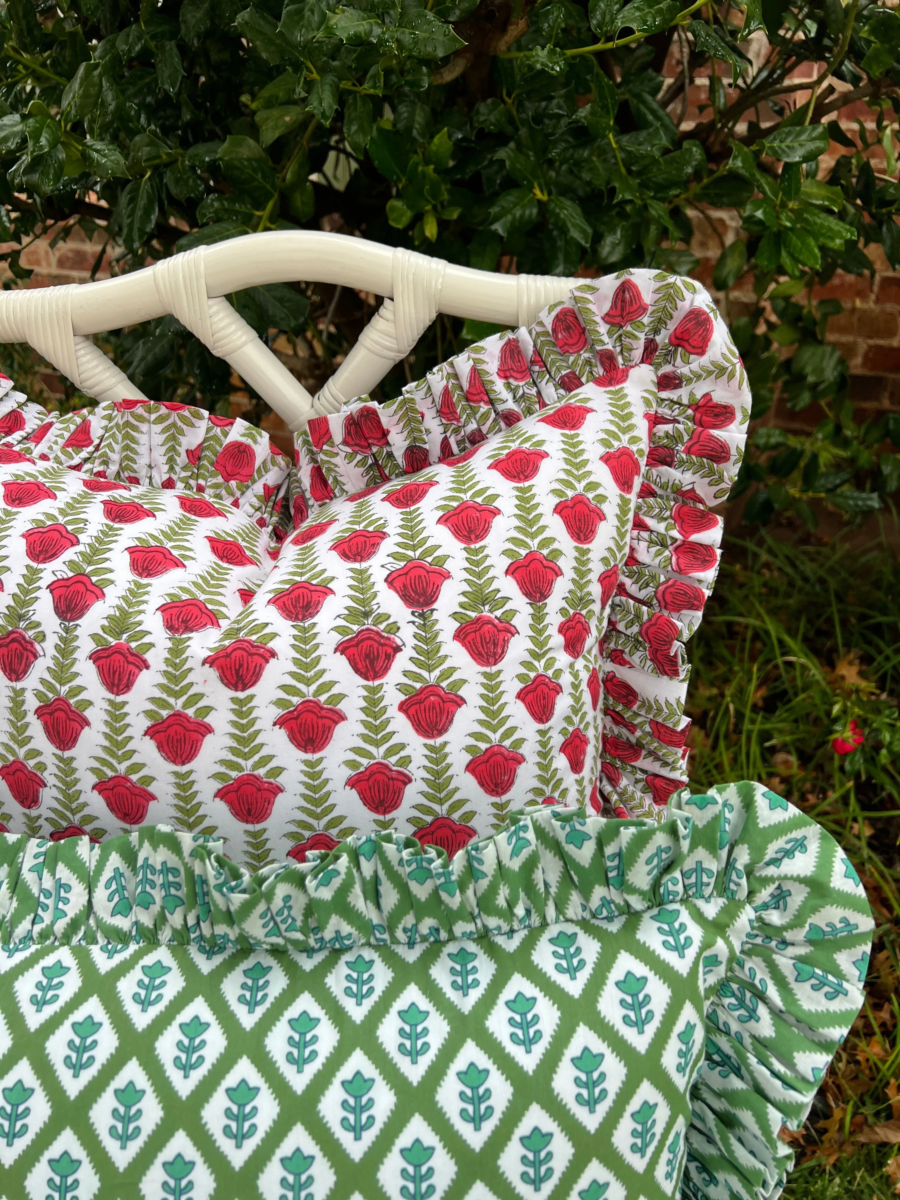 Red and green block print pillow cover with ruffle trim